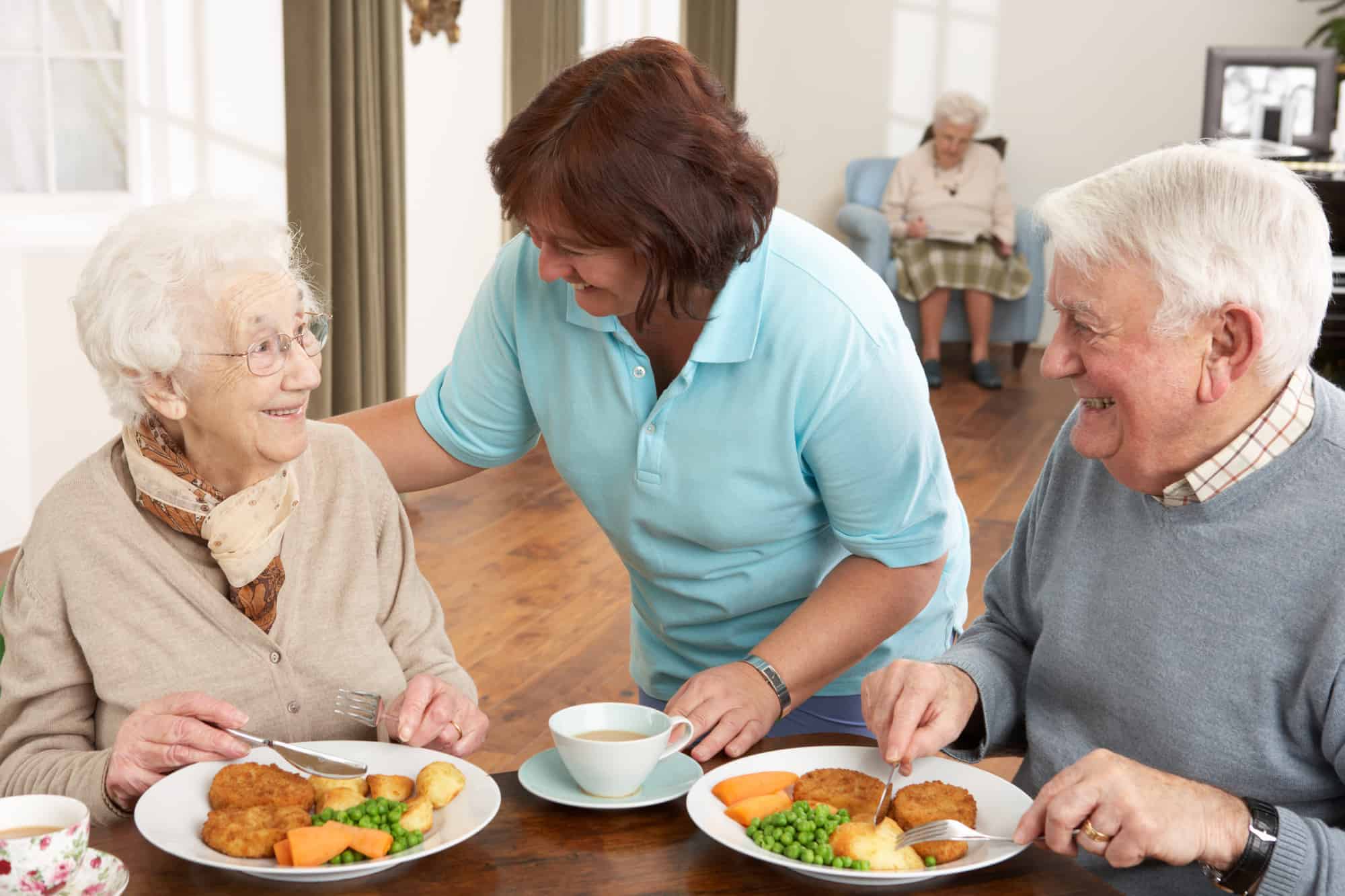 Senior Couple being served meal