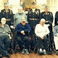 Colonial Courtyard at Clearfield residents who are veterans, front row, from left to right: Bill Graham, George Anderson, Vince Ballaratto, William Owens, Andrew Tocimak, and Richard Passmore. Resident veteran Edward Solensky is standing in the center among Veterans Honor Guard of the Clearfield American Legion Post 6 and Clearfield VFW Post 1785.