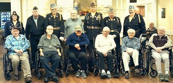 Colonial Courtyard at Clearfield residents who are veterans, front row, from left to right: Bill Graham, George Anderson, Vince Ballaratto, William Owens, Andrew Tocimak, and Richard Passmore. Resident veteran Edward Solensky is standing in the center among Veterans Honor Guard of the Clearfield American Legion Post 6 and Clearfield VFW Post 1785.