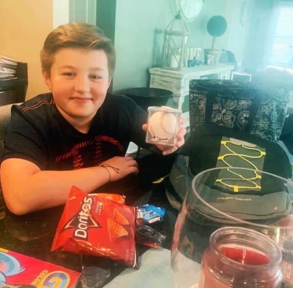 Son of Gary Renwick, Executive Operations Officer at Newhaven Court at Clearview, presents some of his gift.