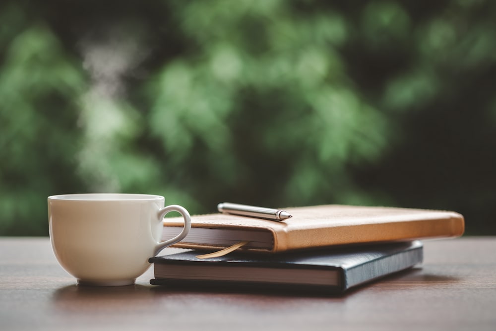Two journals and a coffee mug