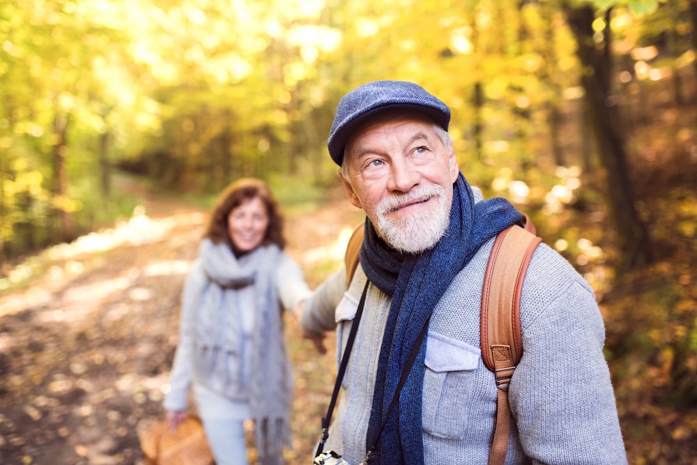 A senior couple on a walk outdoors