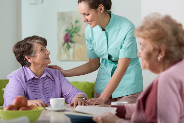 A staff member talking to senior residents