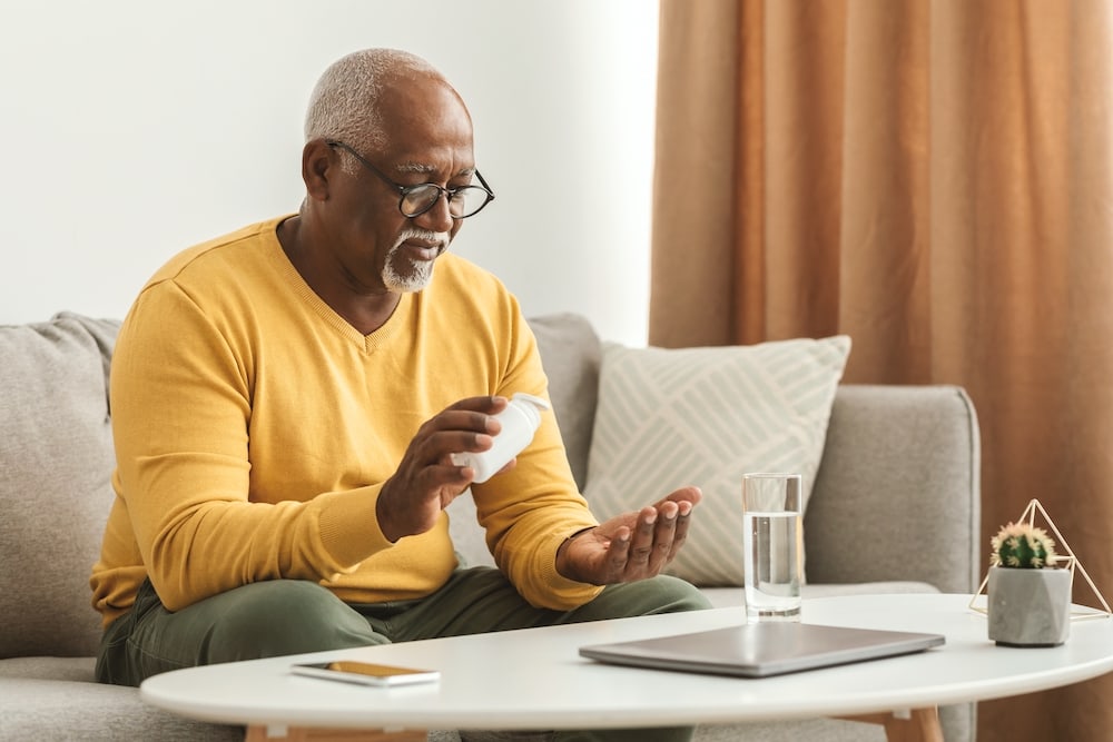 A senior man taking a Vitamin D supplement