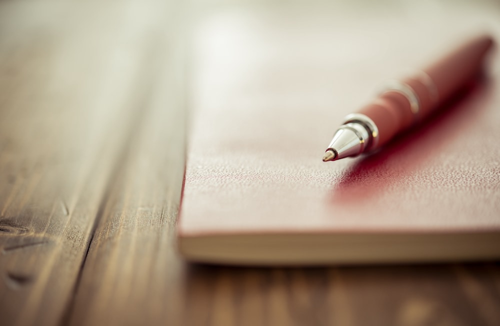 A pen resting on top of a journal