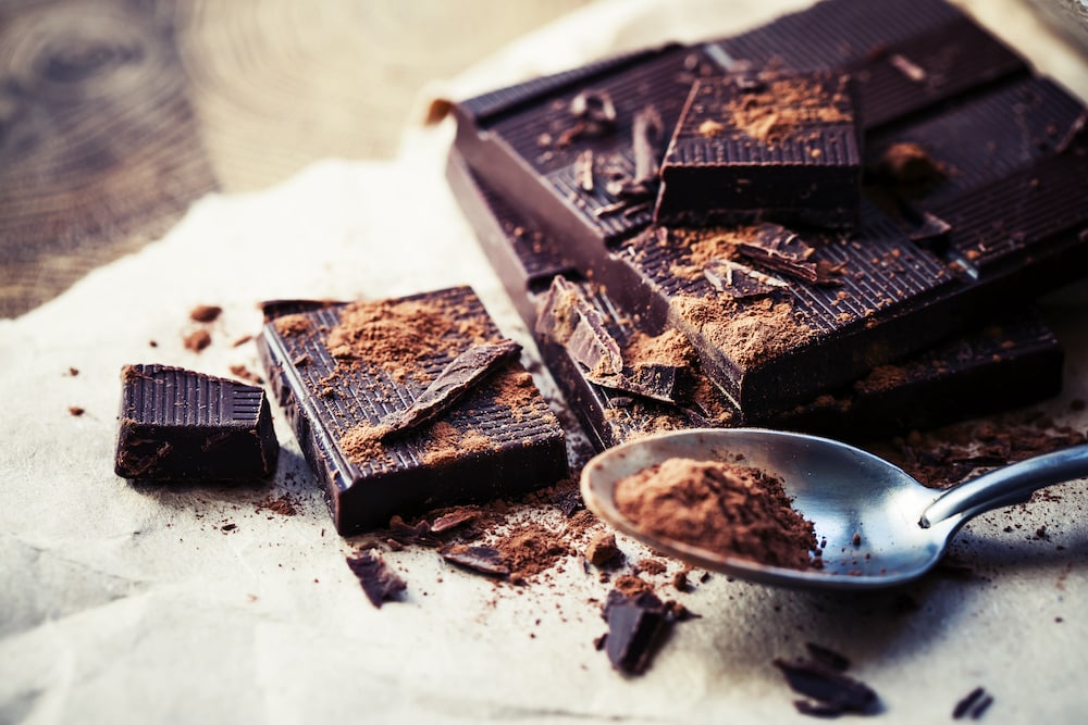 A square of dark chocolate with shaved pieces