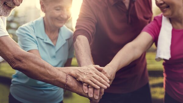 A group of senior hands in a circle