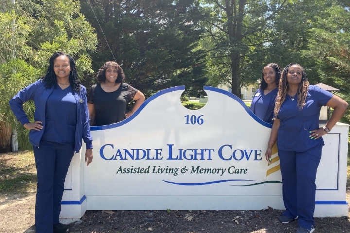 Candle Light Cove Nurses Taking group photo in front of sign