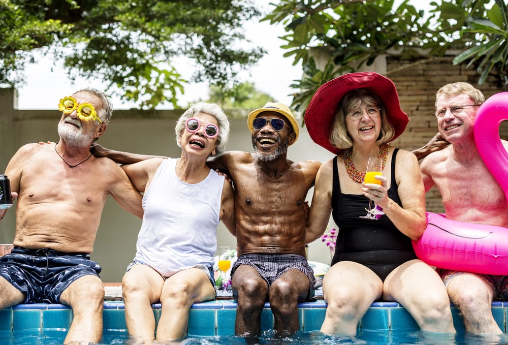Group,Of,Diverse,Senior,Adults,Sitting,By,The,Pool,Enjoying