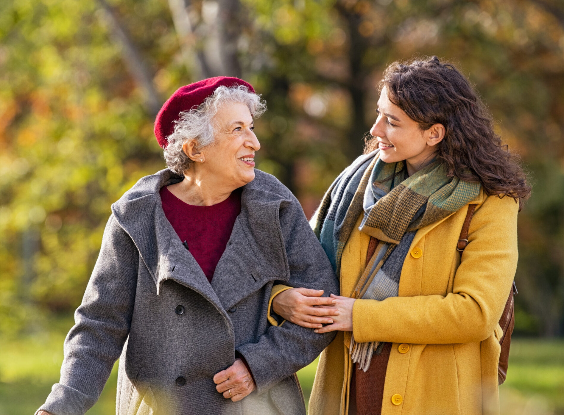 senior mother and daughter walking outside