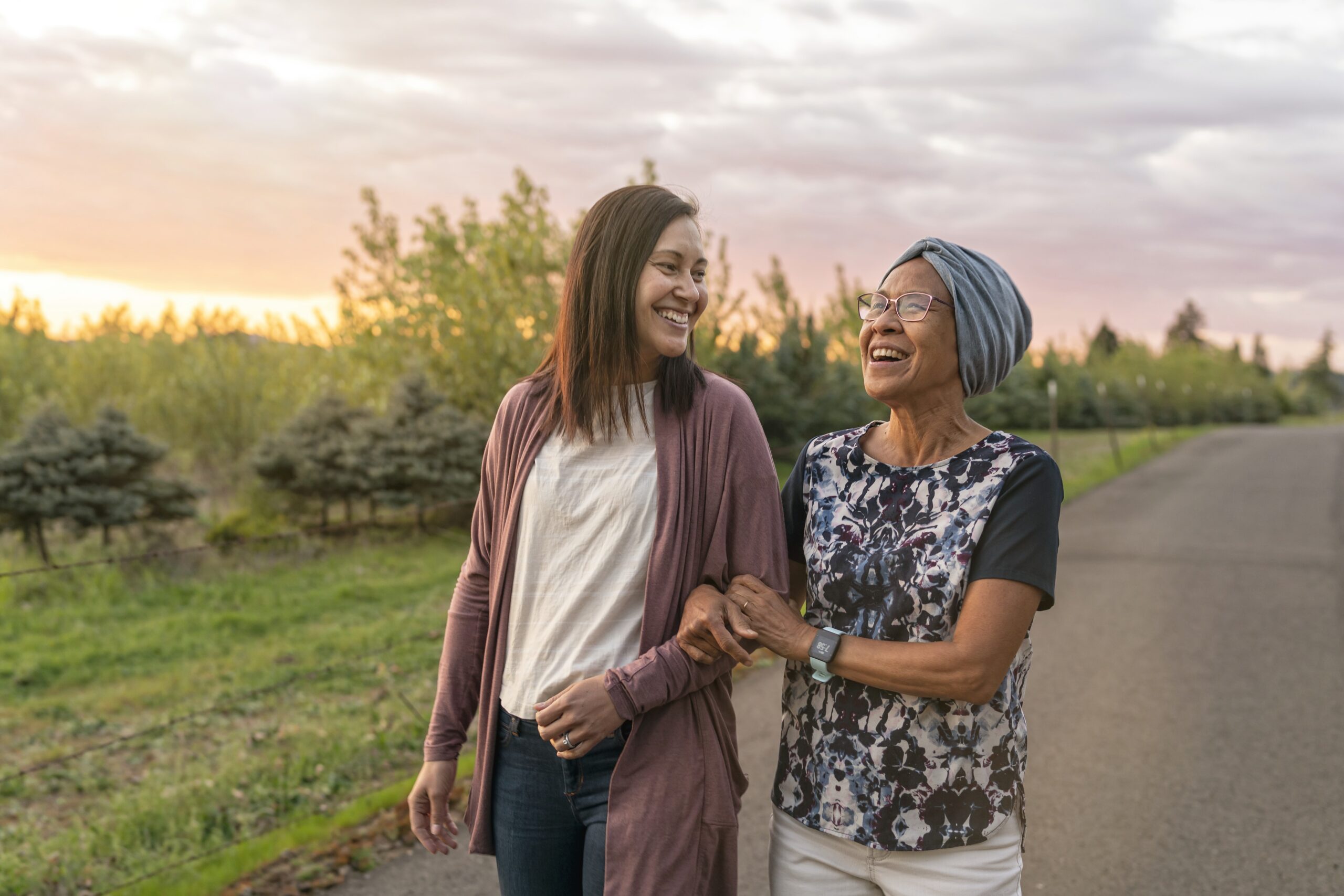 senior mother walking with daughter outside