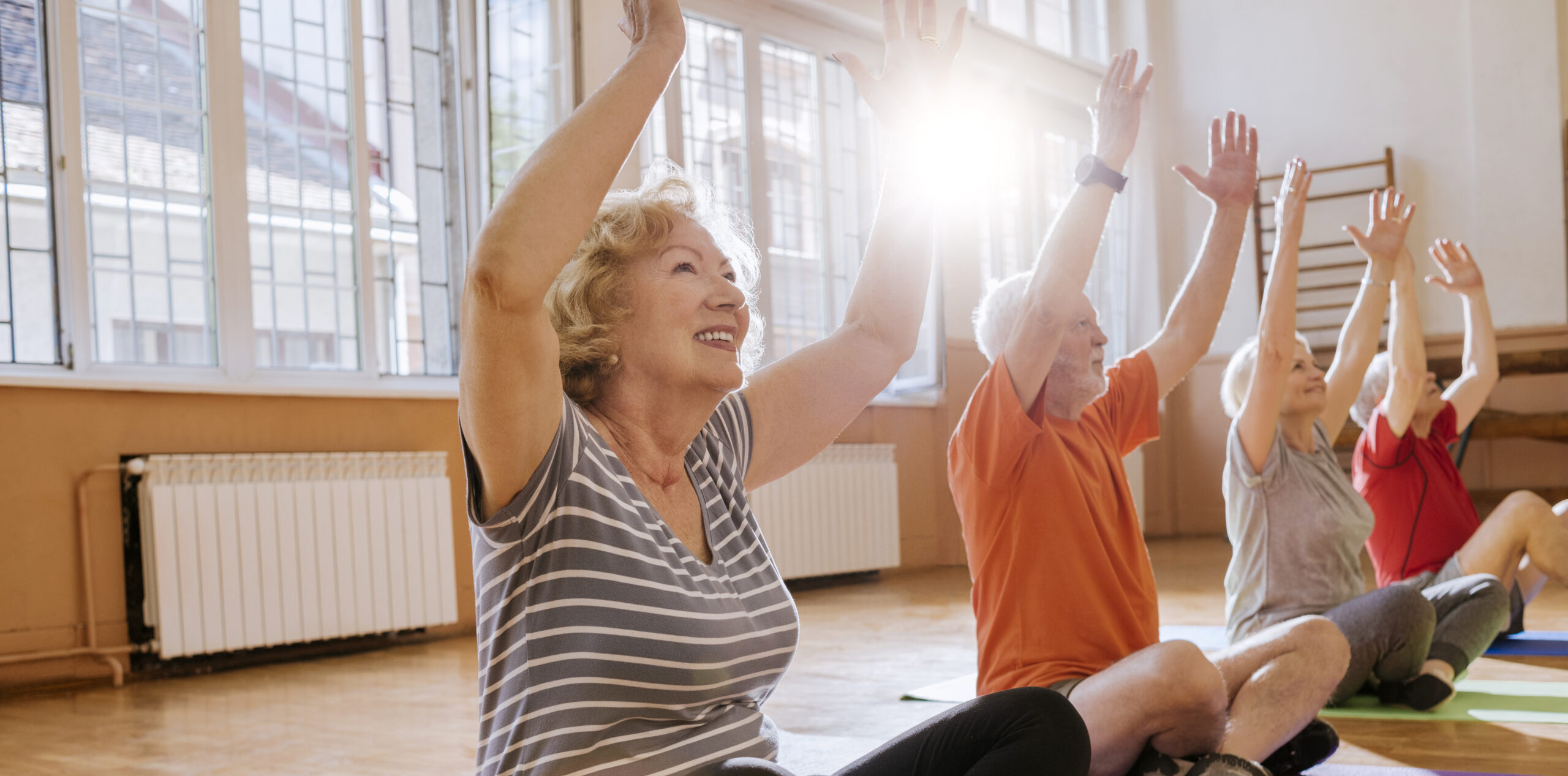 group of cheerful seniors having fun together exercising