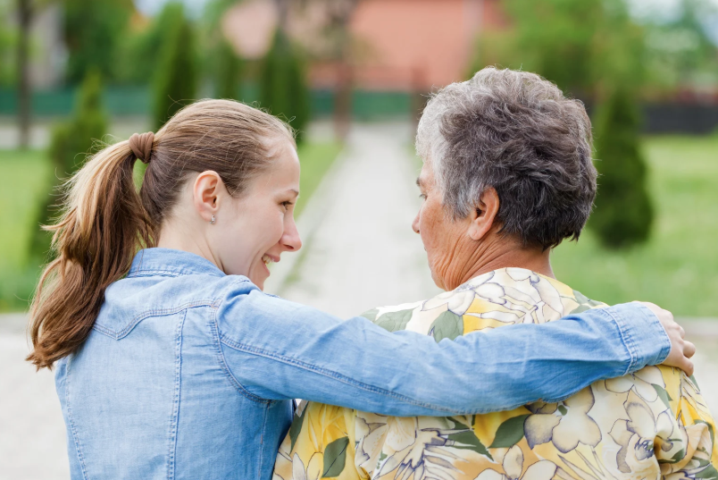 daughter with senior mother walking outside