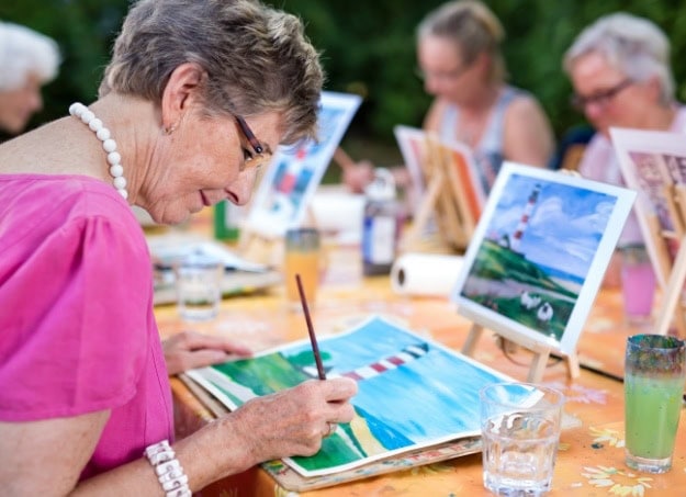 senior woman painting outside