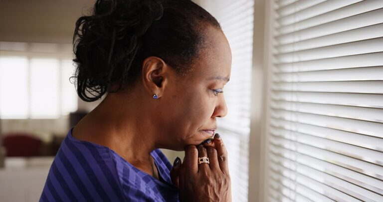 African American Female Looking Out Window