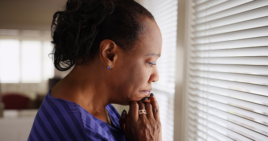 African American Female Looking Out Window