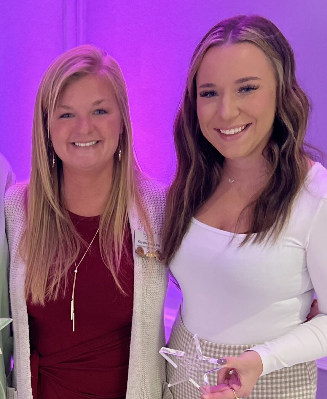 Clare Twentier (right) holds a star-shaped award while standing next to Krystle Pry, Executive Operations Officer at Newhaven Court at Clearview.
