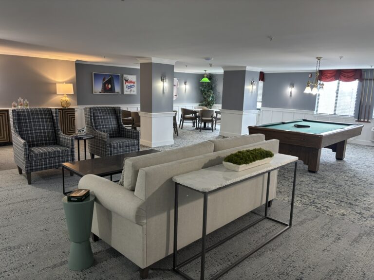 renovated lounge at chestnut ridge wallingford featuring new furniture, a pool table, and modernized common areas for senior living residents.