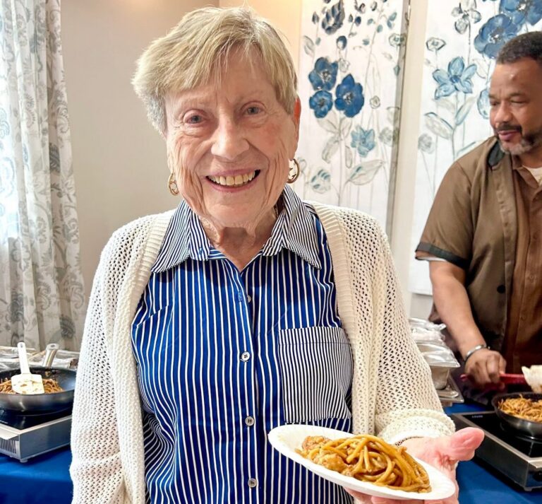 Christine Patchell of Exton Senior Living holding dinner plate
